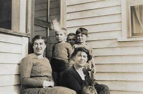 A picture containing sitting, building

Description automatically generated